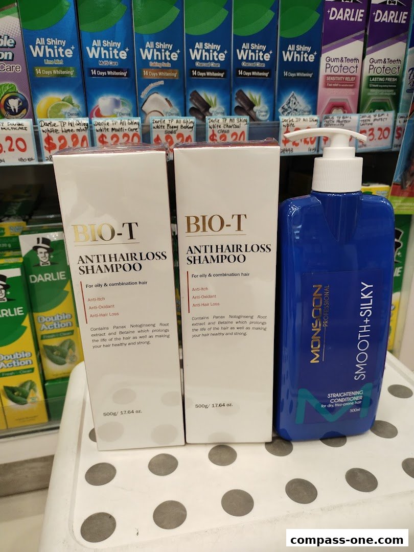 A display of hair care products including BIO-T anti-hair loss shampoo and Monsoon smoothing conditioner.