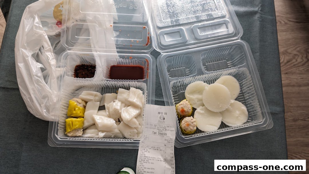 Takeaway containers filled with dim sum items and dipping sauces from Jian Bo Shui Kueh.