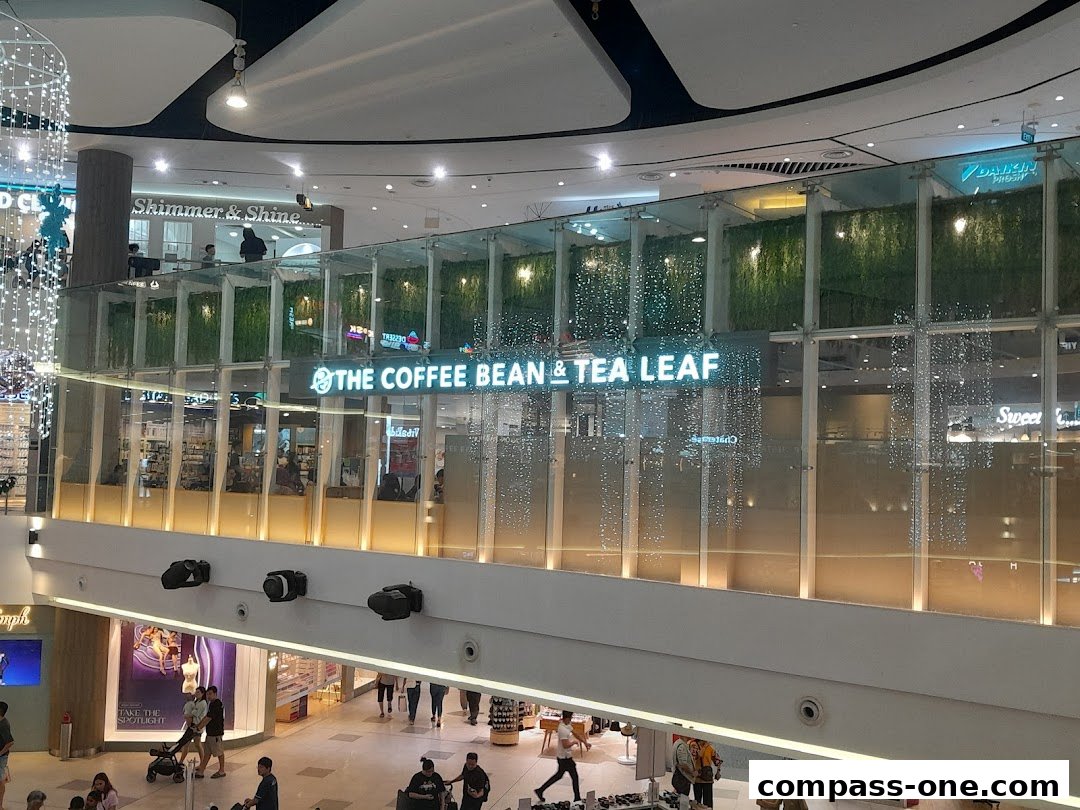 The Coffee Bean & Tea Leaf shop front with neon signage and decorative lights.