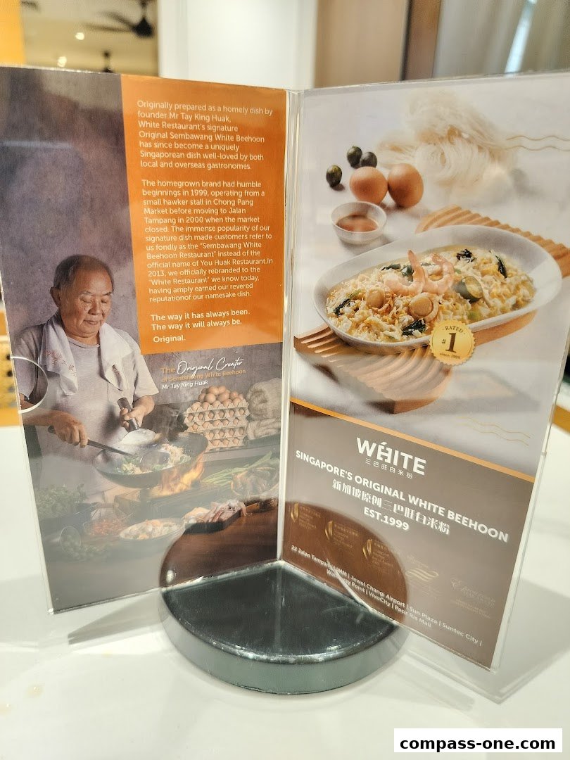 A tri-fold display featuring the founder of White Restaurant and their signature dish.