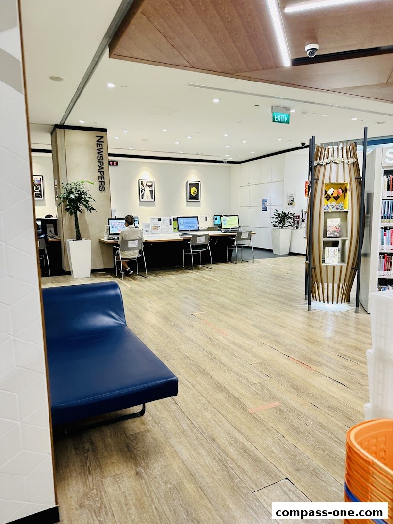 Interior of a library with computers, seating, and bookshelves.