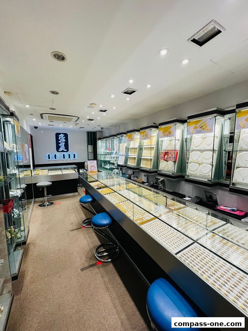 Interior view of a well-lit jewelry store with display cases filled with gold and diamond jewelry.