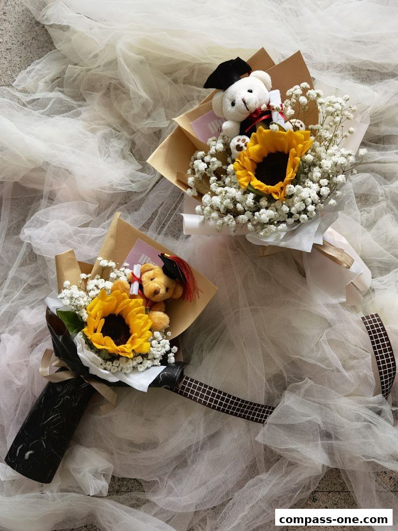 Two graduation bouquets with sunflowers, baby's breath, and teddy bears.