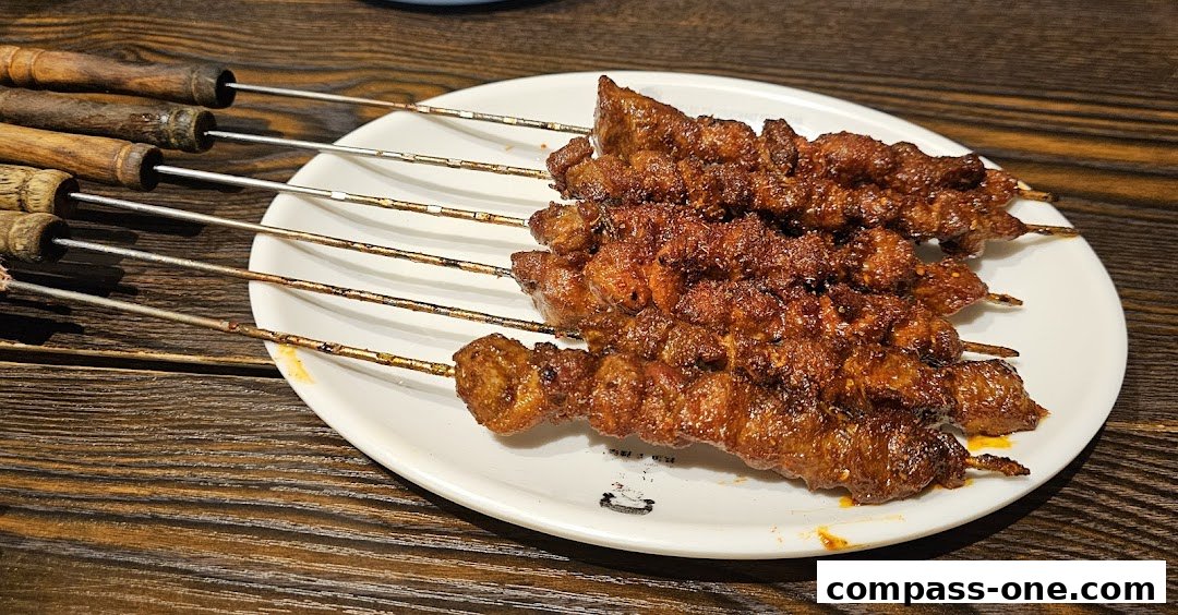A plate of grilled lamb skewers seasoned with spices on a wooden table.