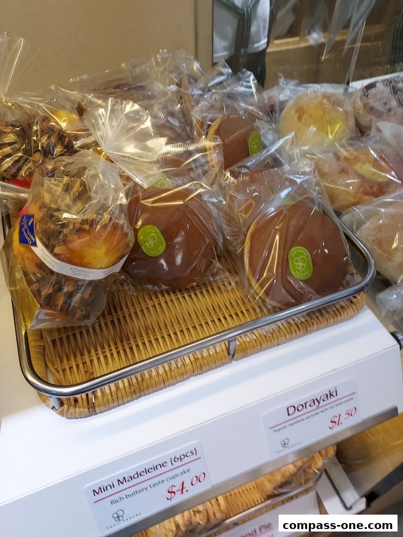 A display of individually wrapped pastries, including Dorayaki and Mini Madeleines.