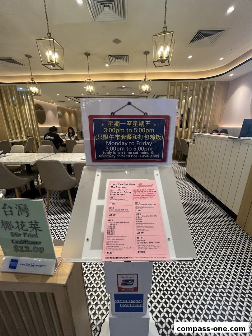 A menu board displays lunch set specials and stir-fried cauliflower at Boon Tong Kee.