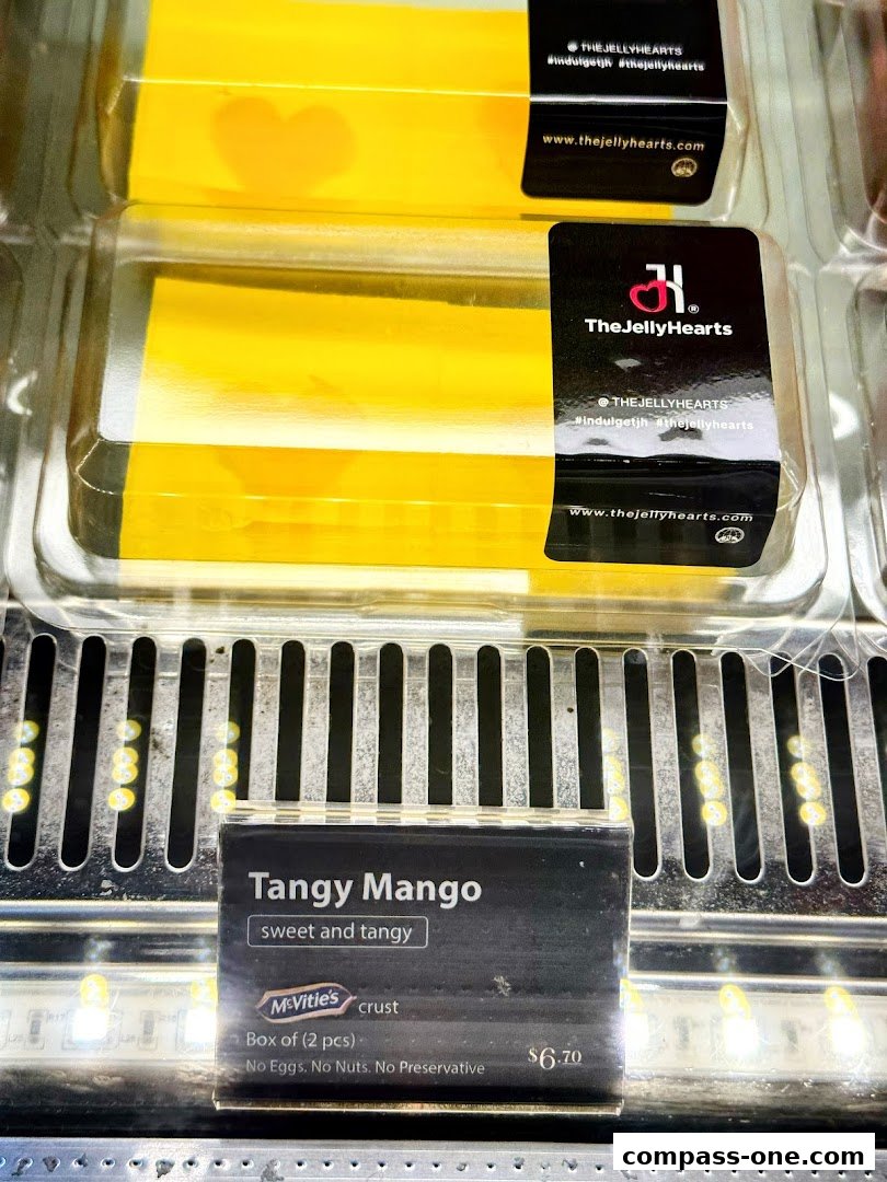 Close-up of yellow jelly desserts with 'Tangy Mango' labeling and branding.