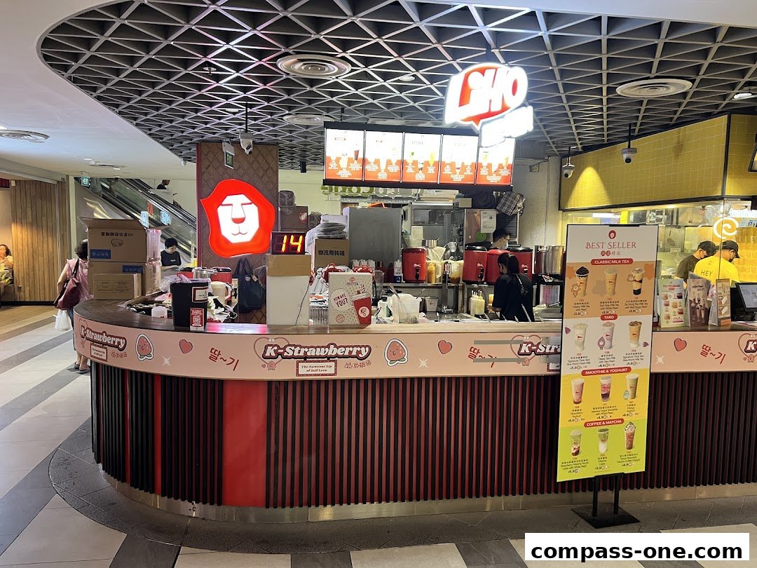A LiHO TEA shop counter with a menu board and staff serving customers.