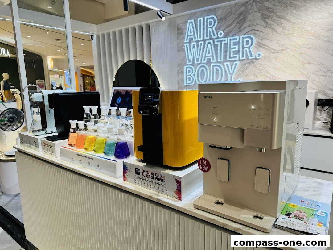 A display of Novita water purifiers and related products, with colorful liquids in beakers.