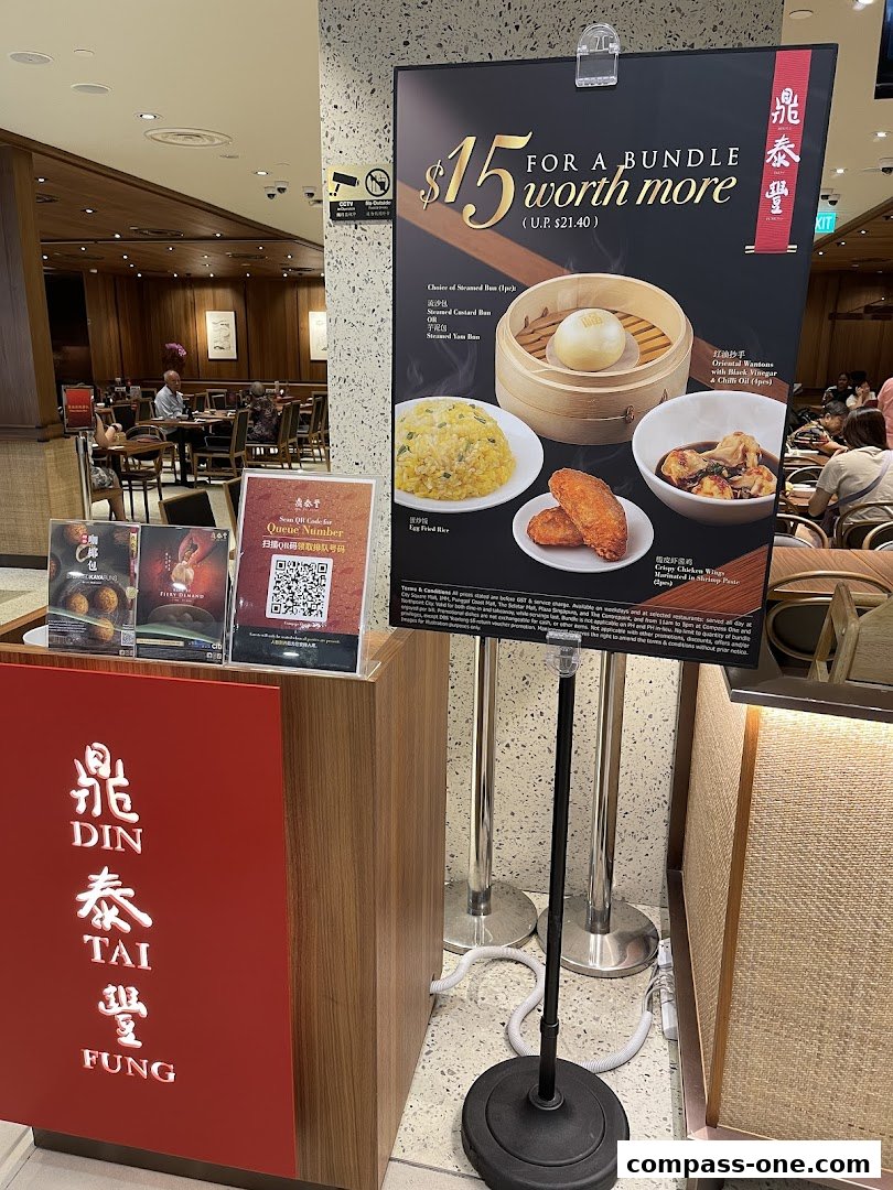 Din Tai Fung restaurant with a promotional poster for a $15 bundle deal.
