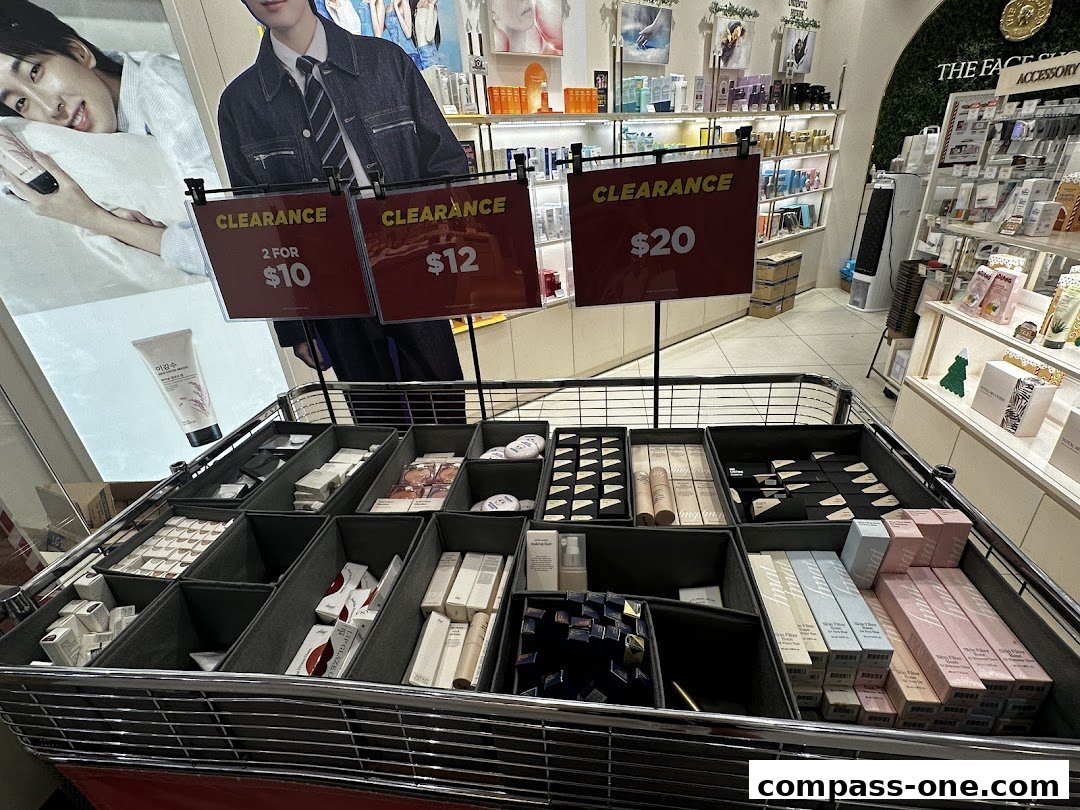 A display of skincare products with clearance sale signs in a retail store.