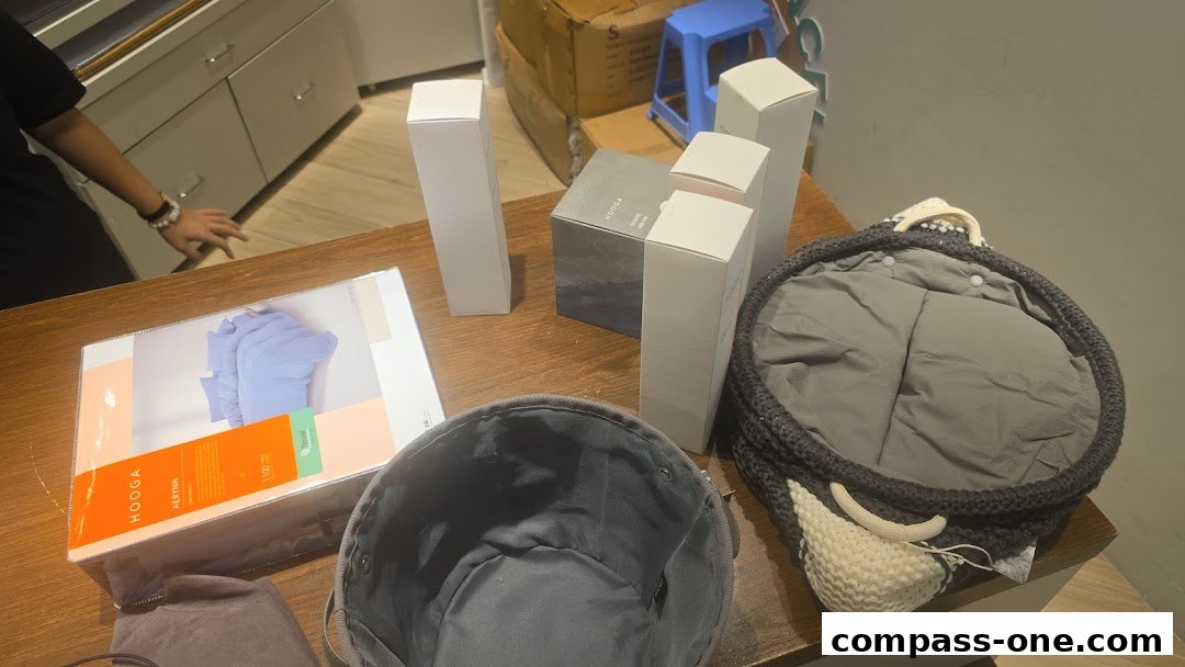 HOOGA products including boxes and a basket are displayed on a wooden table.