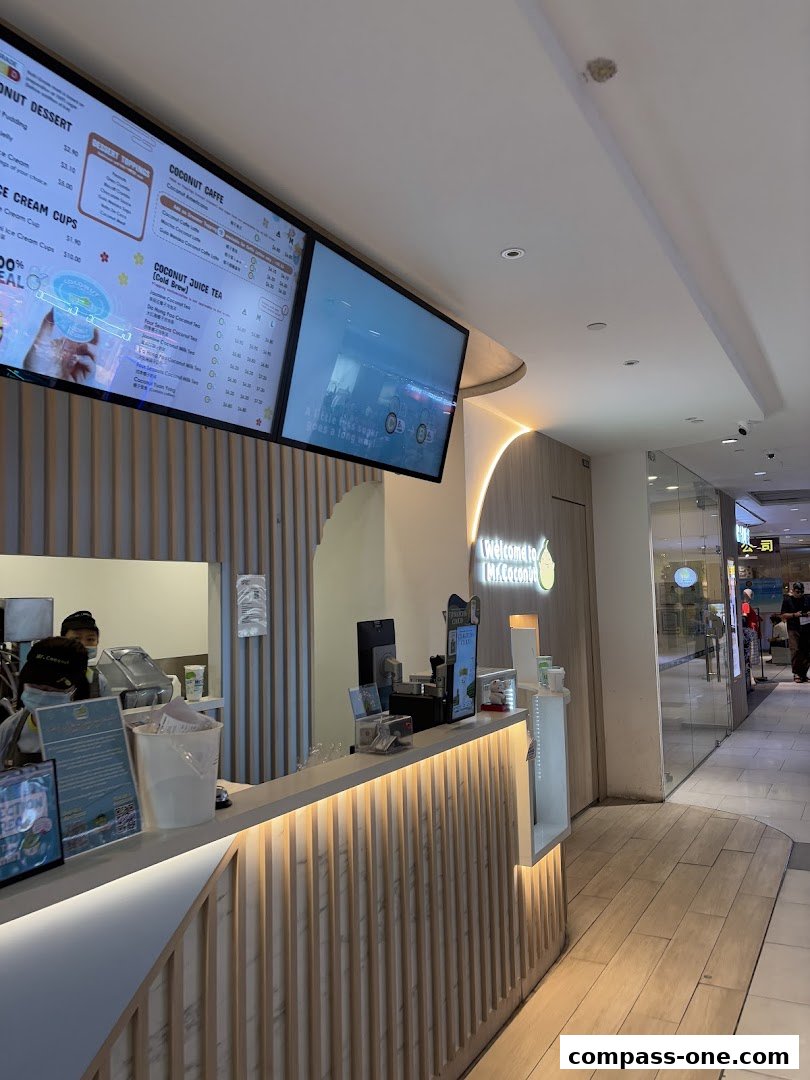 A menu board displaying coconut desserts, coffees, and juices at Mr. Coconut.