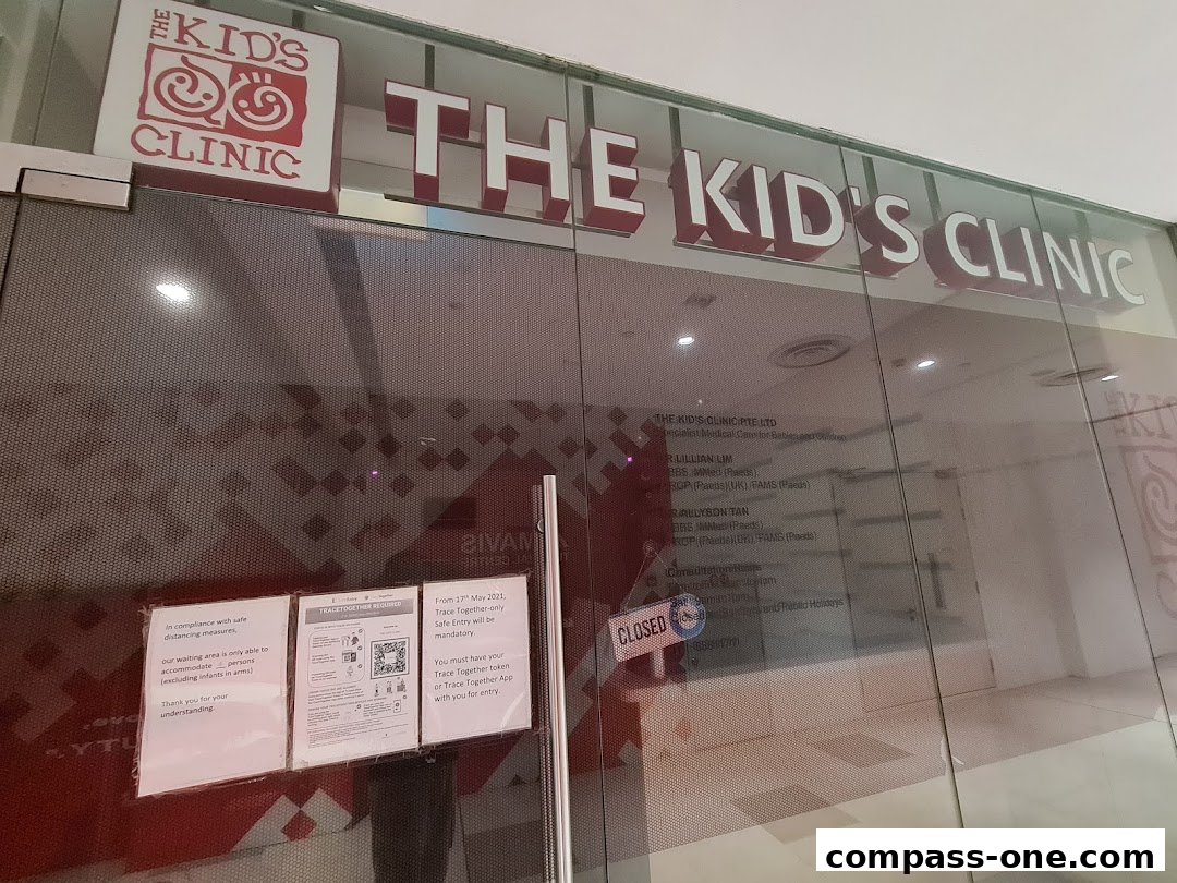 The exterior of 'The Kid's Clinic' with its name and logo visible on the glass facade.