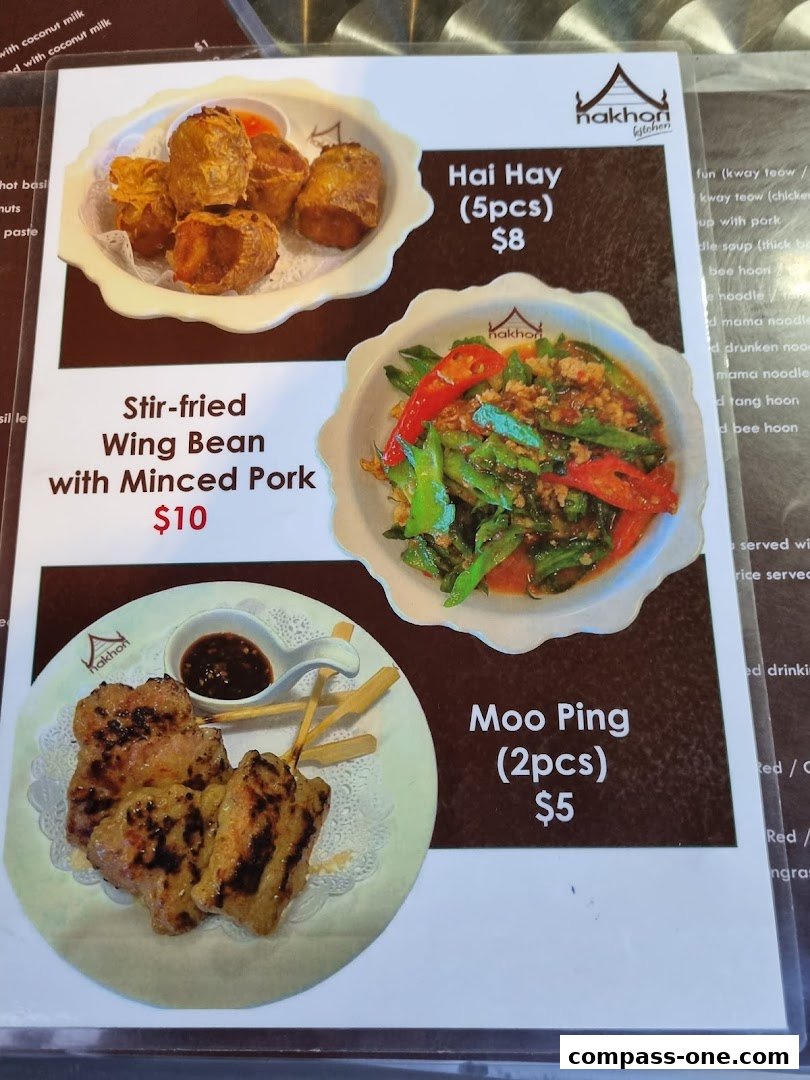 A menu from Nakhon Kitchen featuring Thai dishes like Hai Hay, Stir-fried Wing Bean, and Moo Ping.