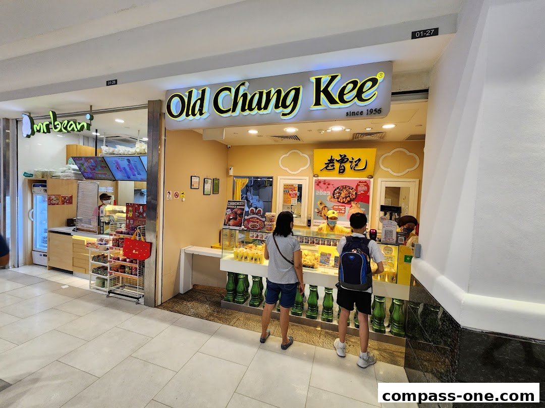 Old Chang Kee shop with customers ordering food and drinks.