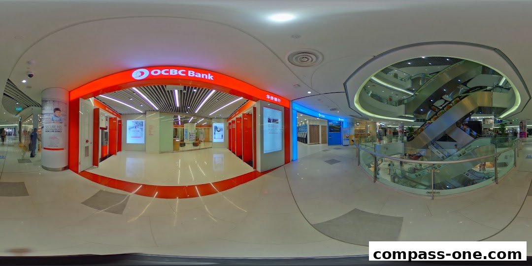 The entrance of OCBC Bank at Compass One mall, featuring ATMs and promotional displays.