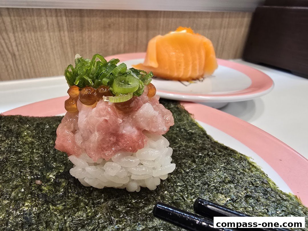 Close-up of sushi with chopped tuna, roe, and green onions on nori.