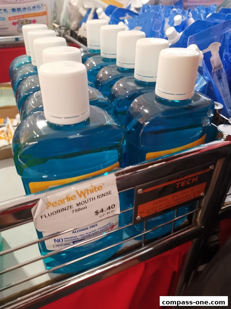 A display of Pearlie White Fluorinze Mouth Rinse bottles with a price tag.
