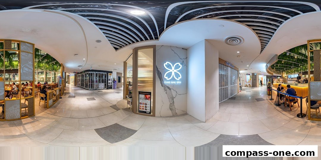 The entrance to Pixie Nail Spa, a modern salon with a glowing logo and marble accents.