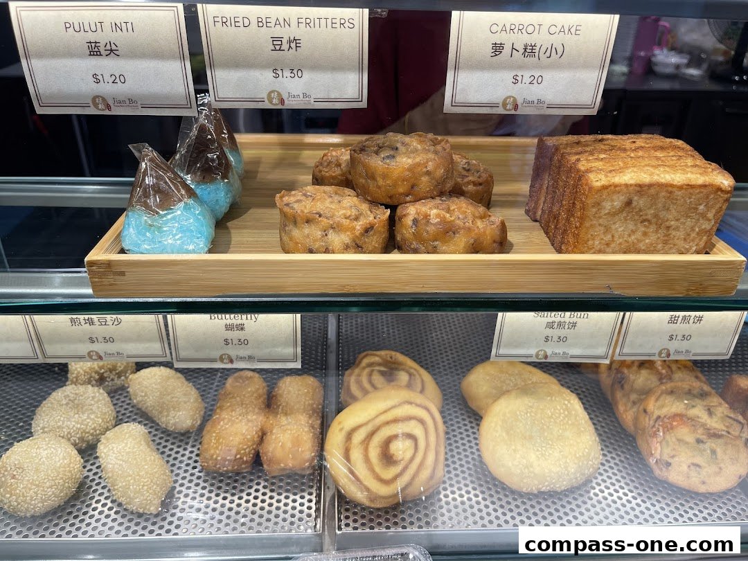 A display case filled with various traditional Asian pastries and snacks from Jian Bo Shui Kueh.
