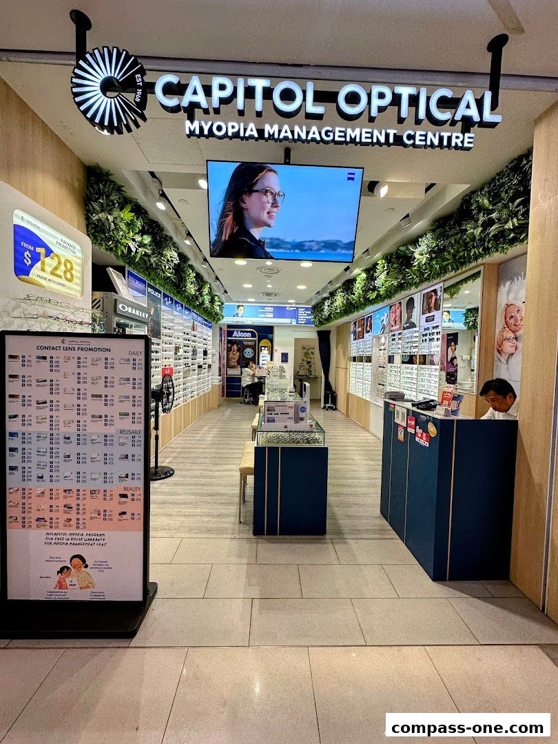 The entrance of Capitol Optical, a myopia management center, showcasing eyewear and promotions.
