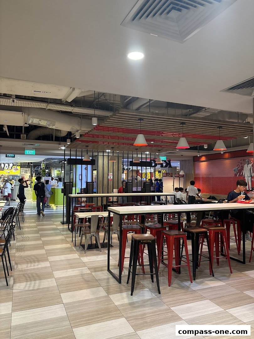 Interior view of a KFC restaurant with seating areas and customers.