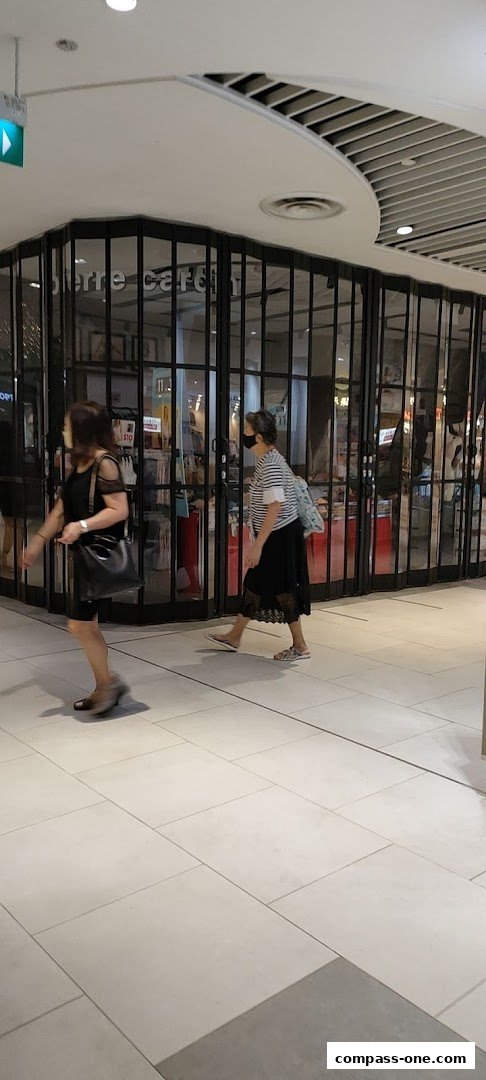 People walk past the closed Pierre Cardin Lingerie shop with its distinctive glass facade.