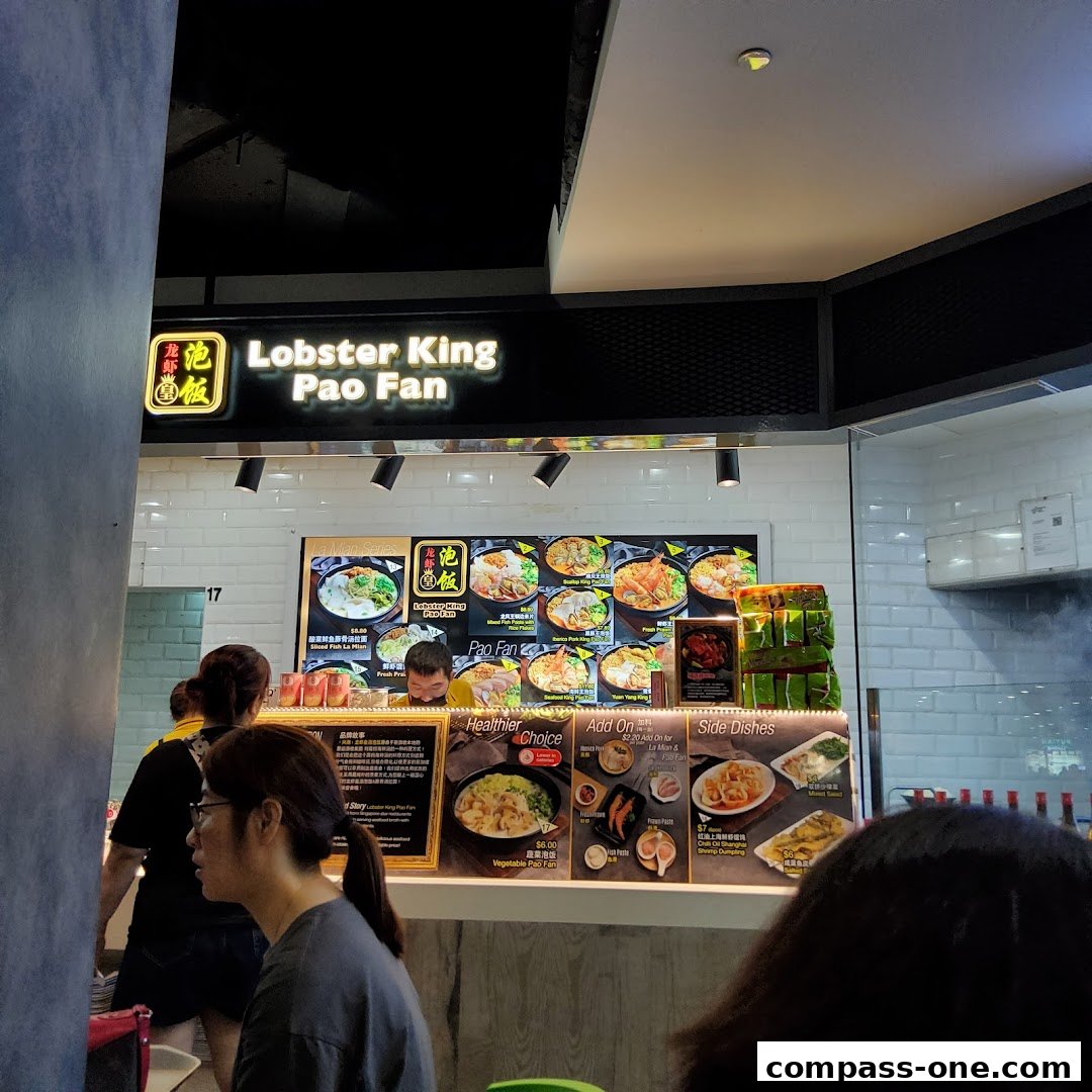 A food stall named Lobster King Pao Fan with various noodle dishes displayed.