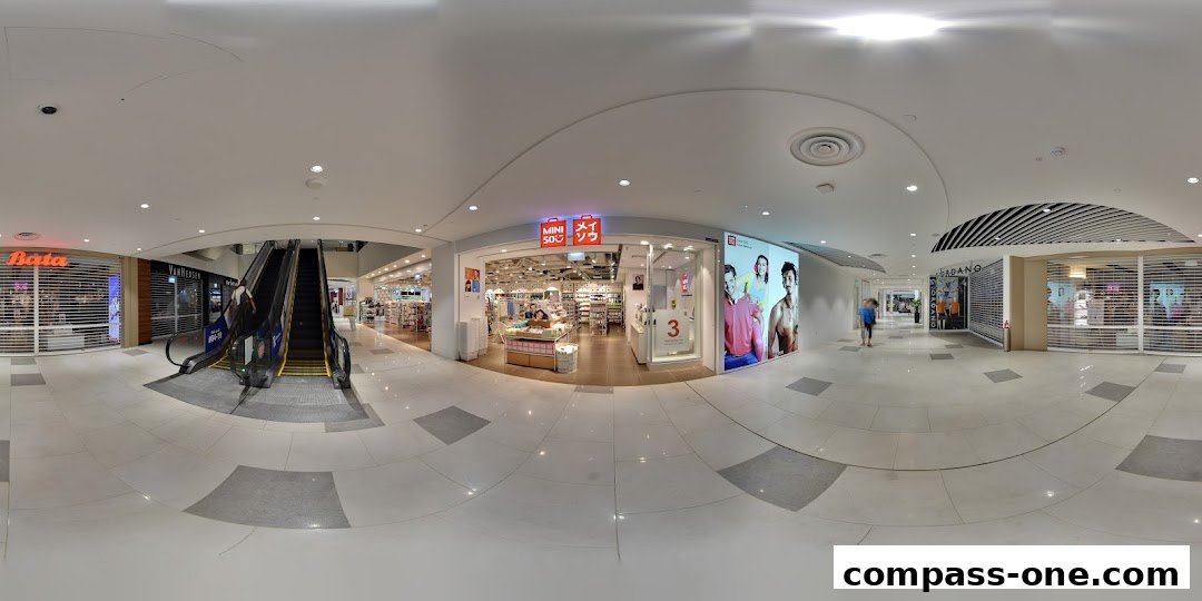 The MINISO Compass One store entrance with displays and products visible inside.
