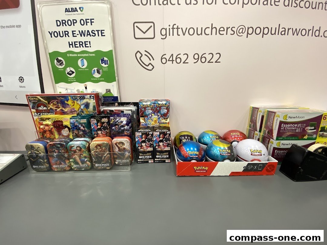 POPULAR Bookstore displays Pokemon and One Piece merchandise, along with an e-waste drop-off sign.