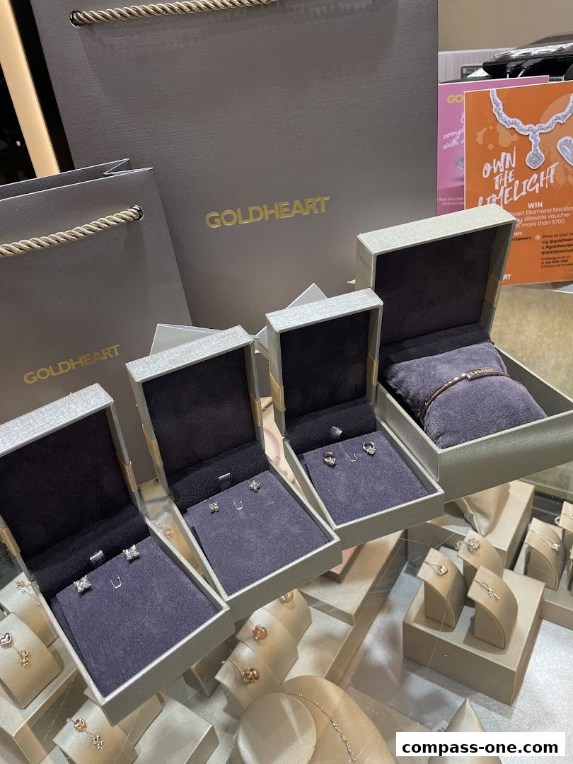 Goldheart jewelry shop display featuring earrings, a bracelet, and shopping bags.