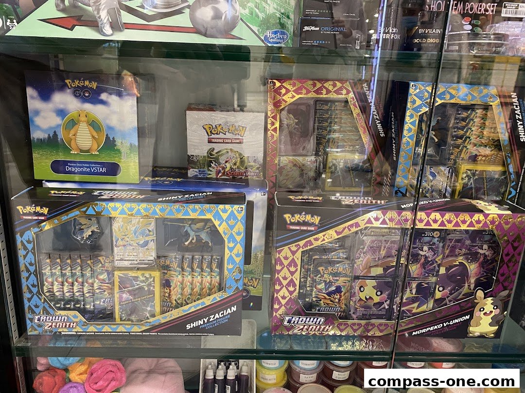 Display case filled with various Pokémon trading card game collections and accessories.