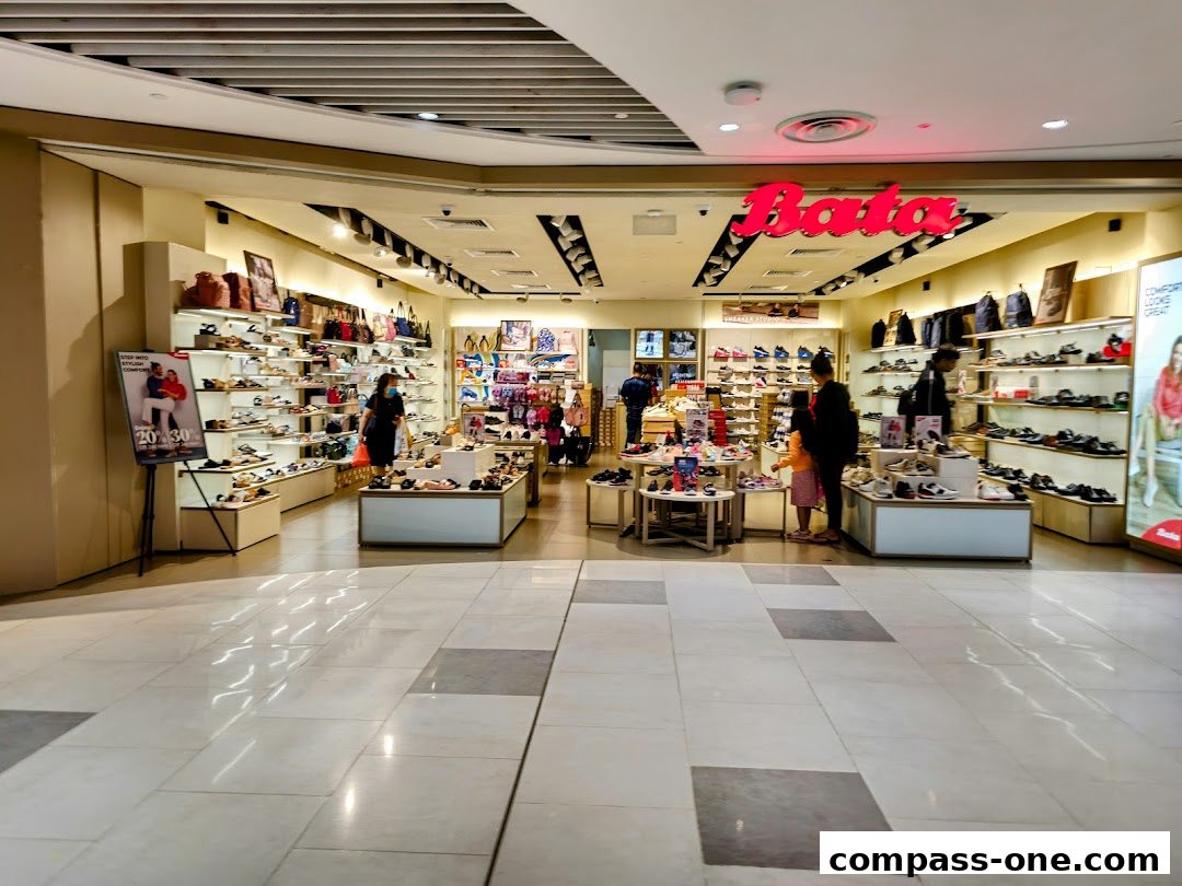 Interior view of a Bata shoe store showcasing a wide variety of footwear and bags.