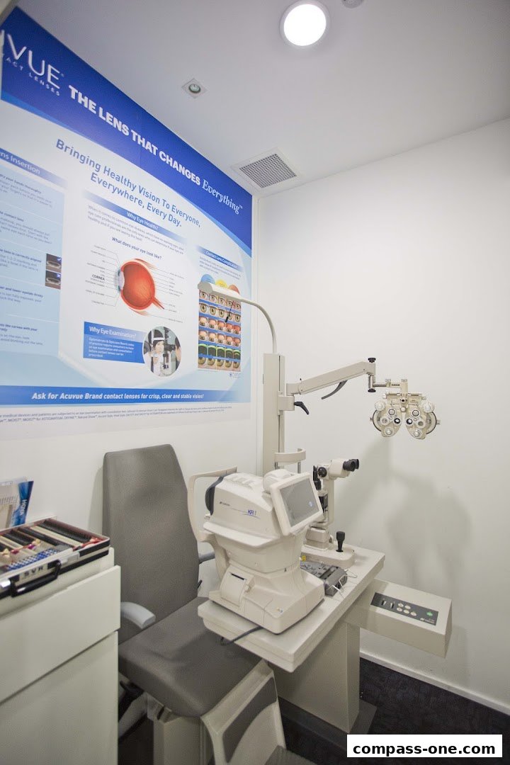 An eye examination room with optical equipment and a poster about vision.