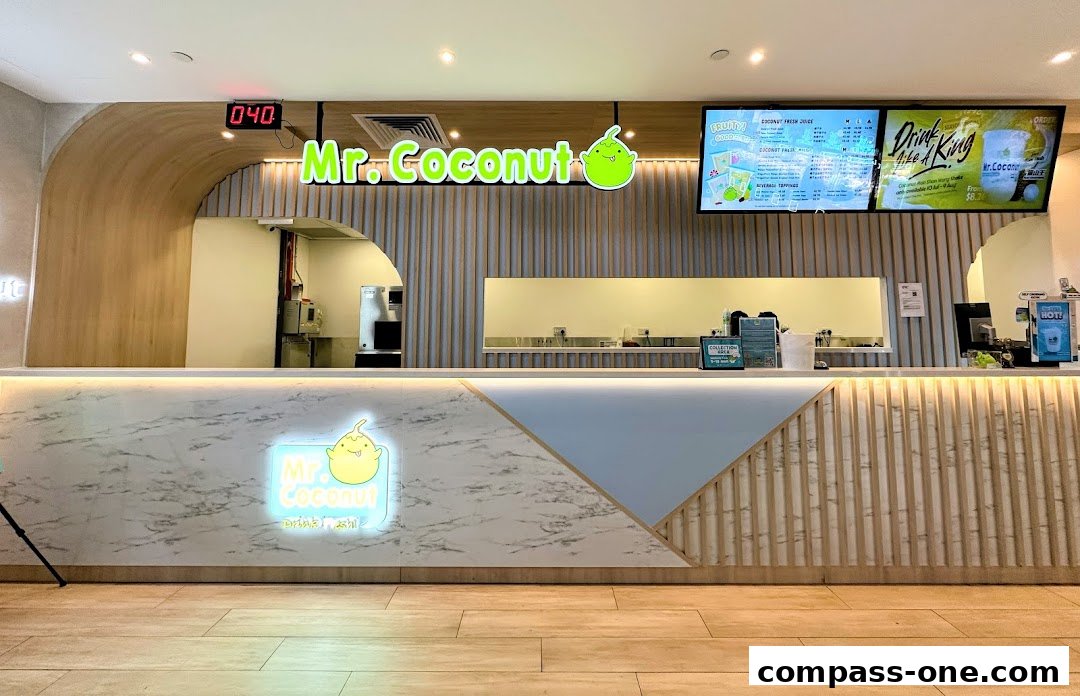 The interior of a Mr. Coconut shop with a prominent counter and menu display.
