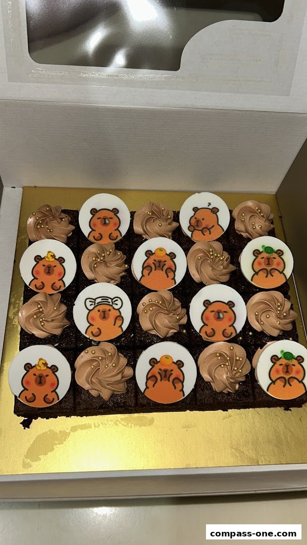 A box of brownies decorated with cute bear faces and chocolate frosting.