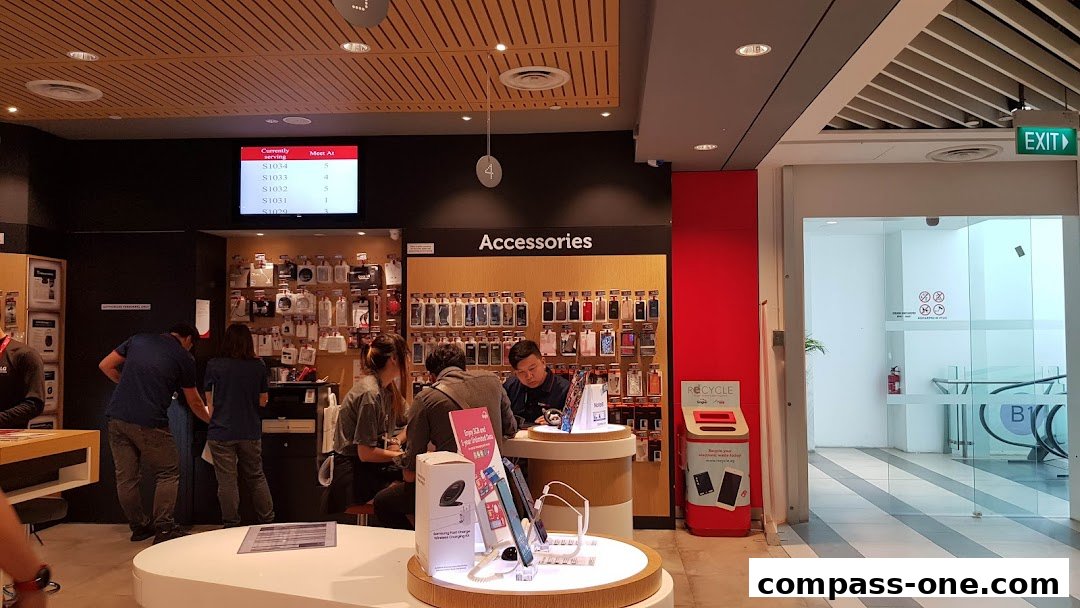 Interior of a Singtel Exclusive Retailer shop with accessories and customers being served.