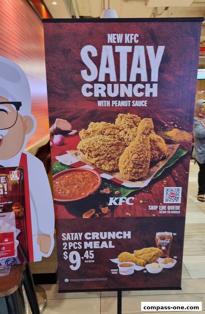 A promotional banner for KFC's new Satay Crunch chicken meal with peanut sauce.