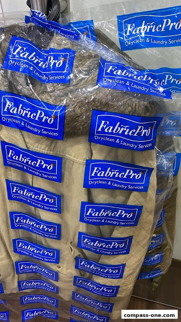 Garments are neatly packaged in plastic bags with the FabricPro Dryclean & Laundry Services logo.