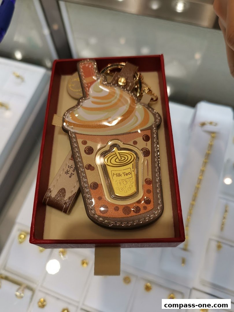 A bubble tea themed keychain displayed in a red gift box at a jewelry store.