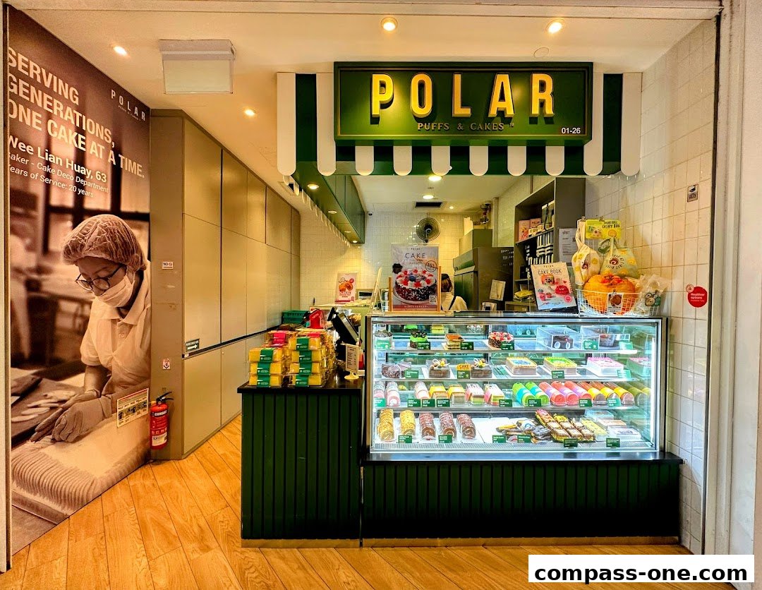 A Polar Puffs & Cakes shop with a display case full of colorful cakes and pastries.
