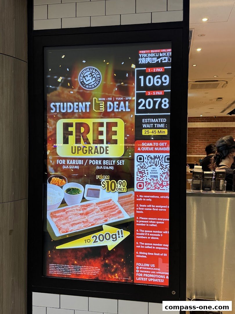 A digital display advertises a student deal for Yakiniku Like, offering a free upgrade and a set meal.