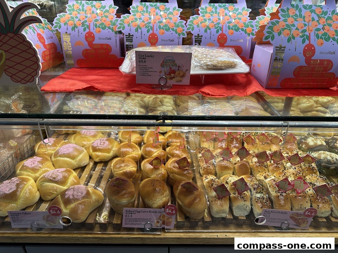A display case filled with various baked goods, including buns and pastries, from BreadTalk.