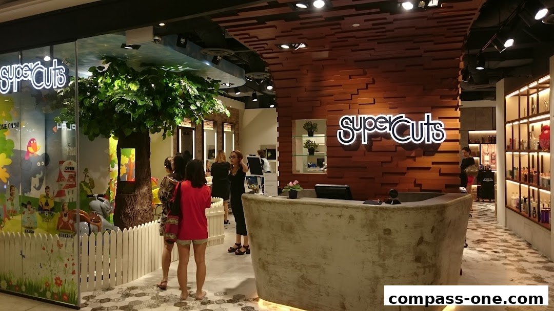 The entrance and reception area of a Supercuts hair salon with a modern design.