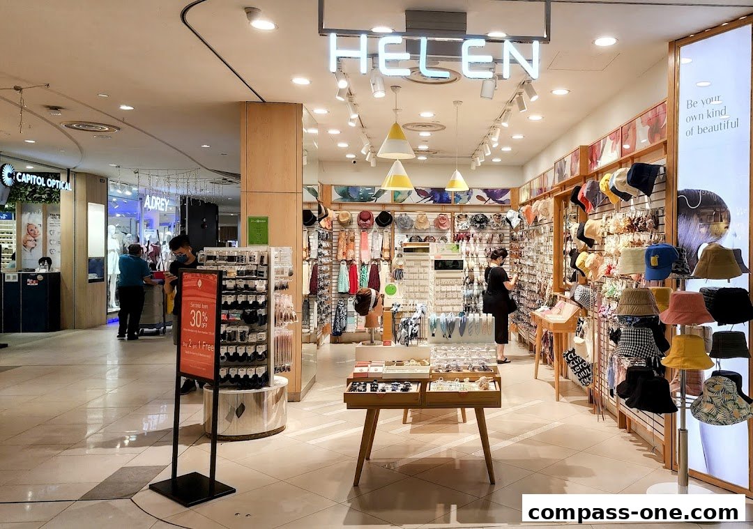 Interior view of a fashion accessories shop with hats, scarves, and jewelry on display.