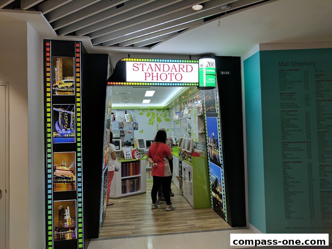 The entrance of Standard Photo, a shop with film strip decorations and a mall directory.
