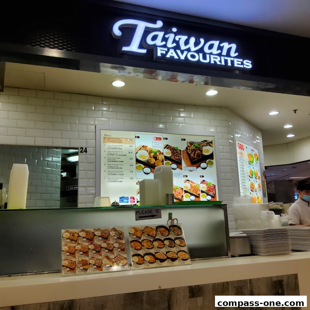 A food stall counter with a menu displaying Taiwanese dishes and food pictures.