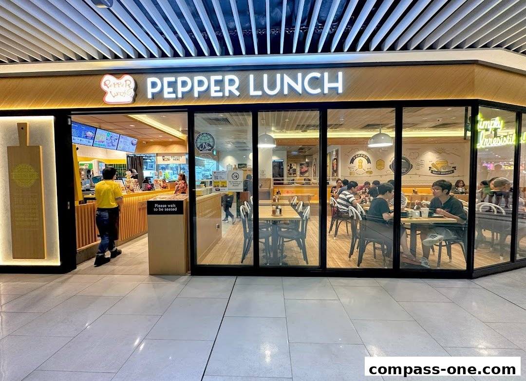 The exterior of a Pepper Lunch restaurant with customers dining inside.