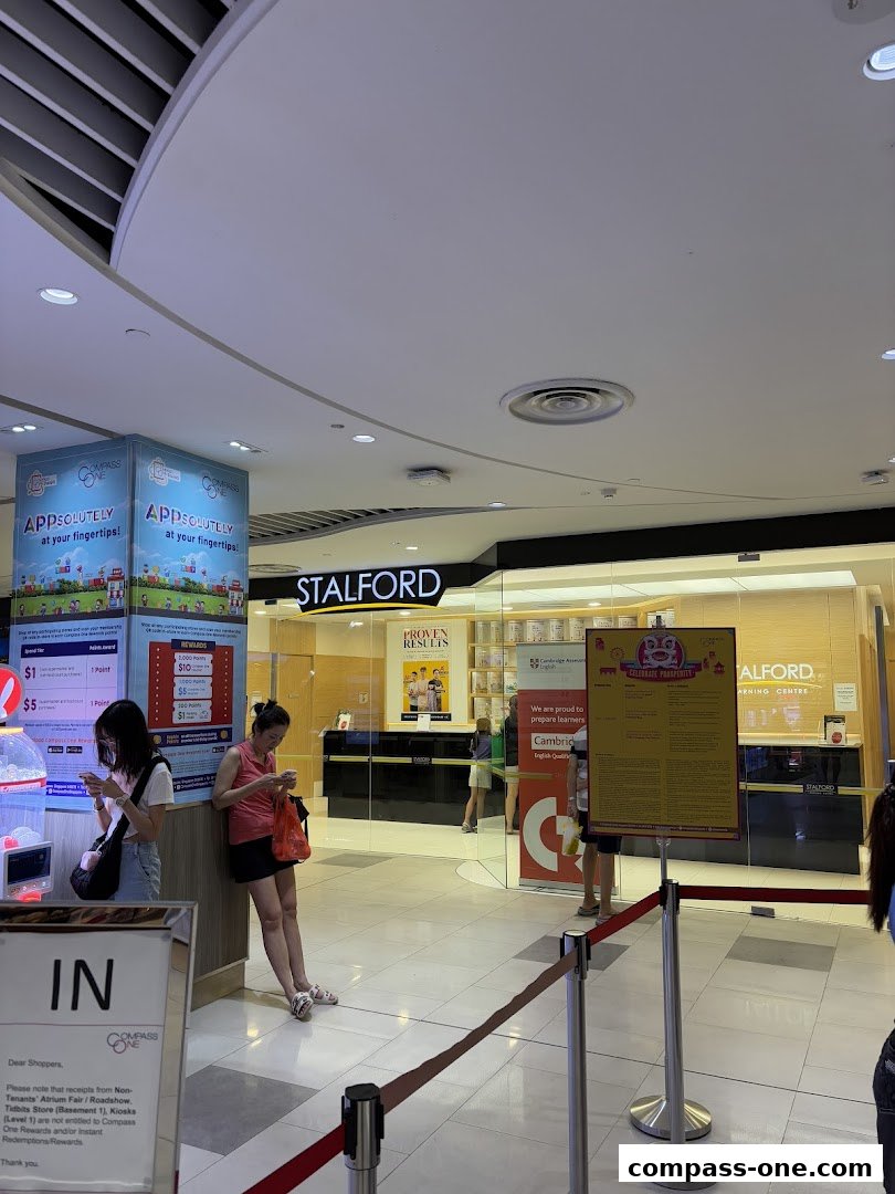 The entrance to Stalford Learning Centre at Compass One, with promotional posters and shoppers.